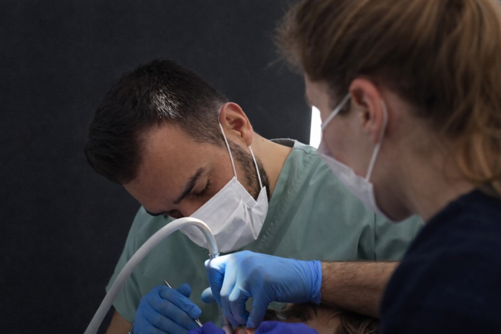 Dr Hüseyin Ay performing dental implant surgery on international patient at dental clinic in Antalya Turkey